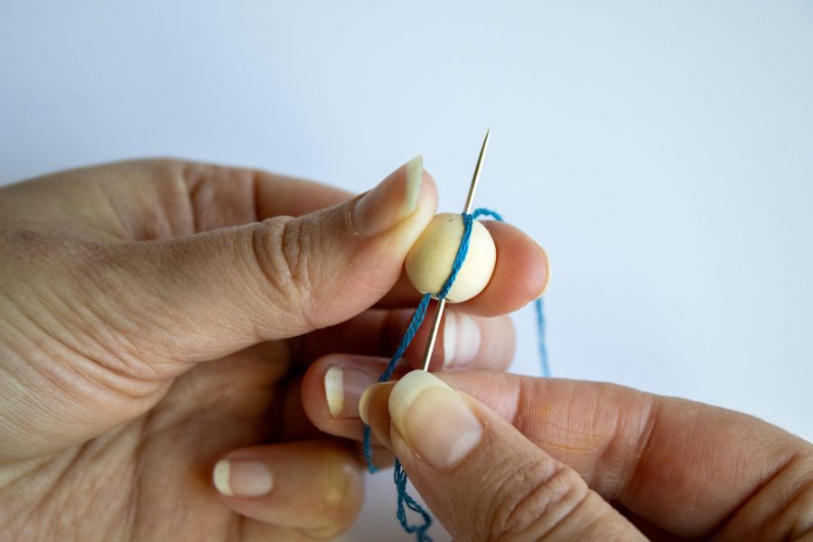 Wrapping a bead with cotton thread and a chenille needle
